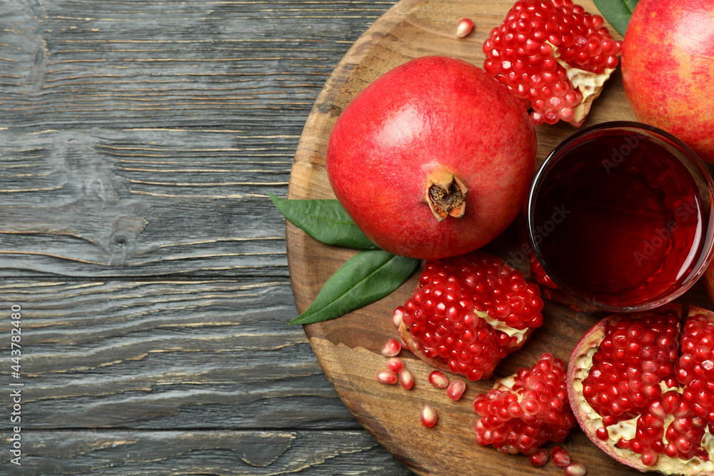 Board with pomegranate juice and ingredients on wooden table Board with pomegranate juice and ingredients on wooden table