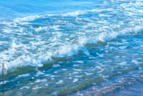 Deep blue and rough sea with lot of sea spray.Blue background.Soft focus blurred image.