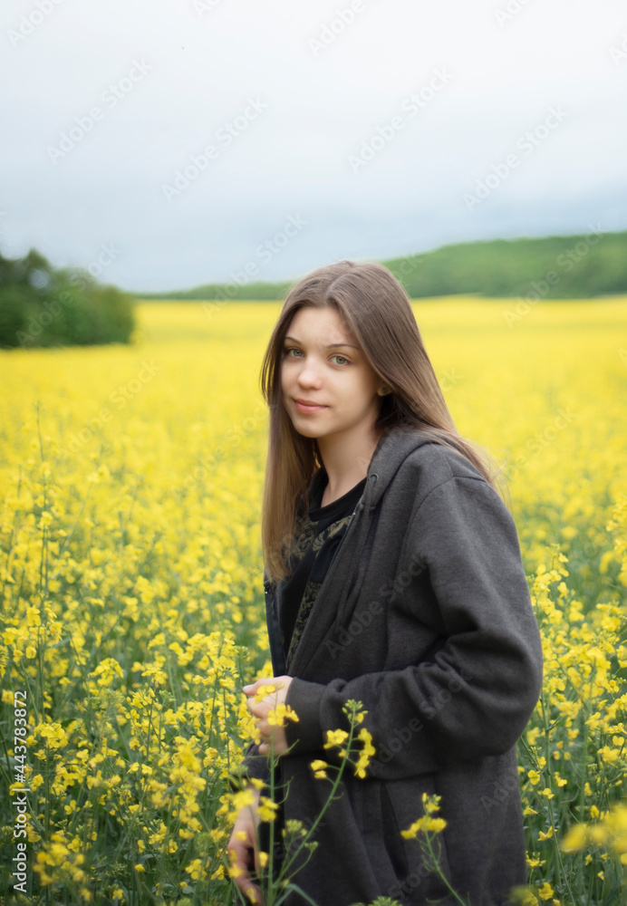 Young girl on yellow rapeseed field Young girl on yellow rapeseed field