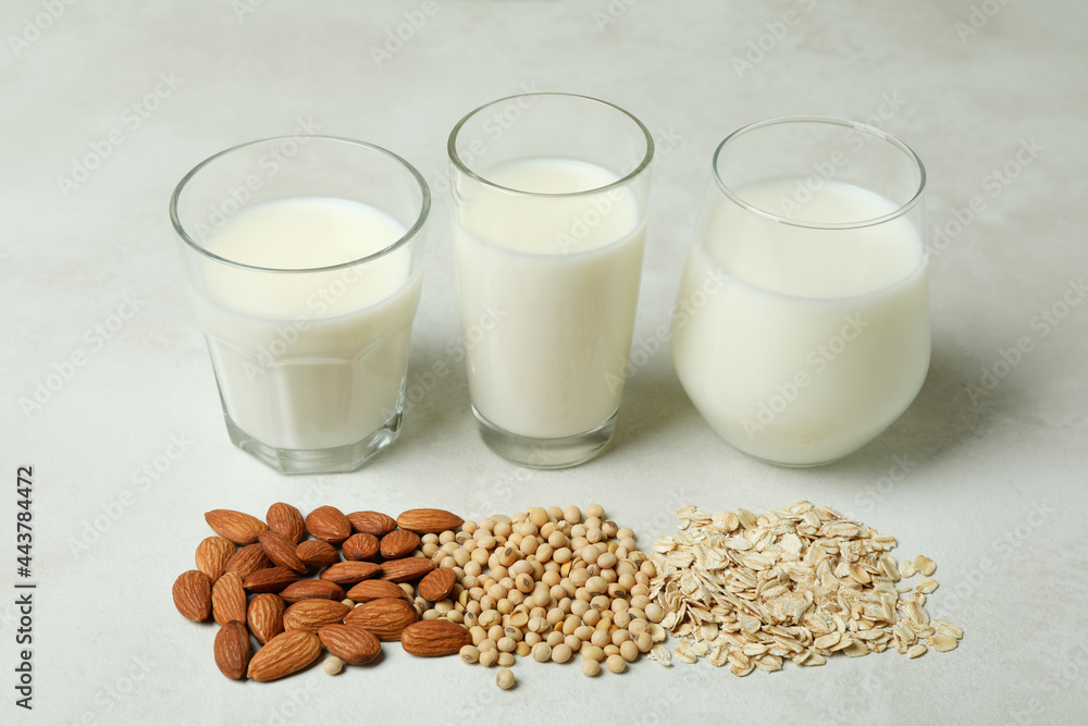 Concept of vegan milk on white textured background Concept of vegan milk on white textured background