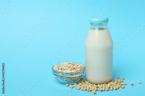 Concept of vegan milk on blue background