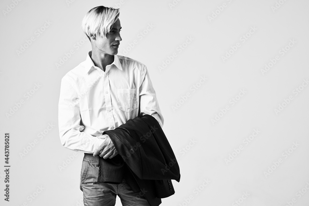 Fototapeta premium handsome man with a jacket in his hands white shirt posing model