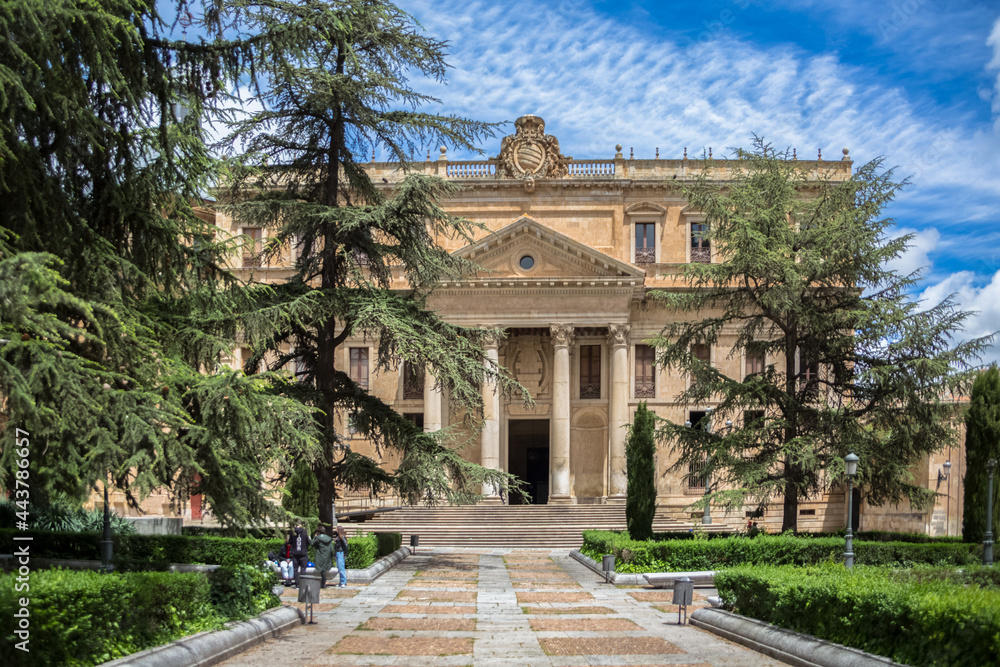 Front facade view at the Faculty of Philology at the University of Salamanca and park and garden surround