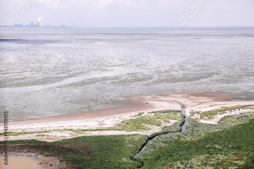 View from above on the dike and the Wadden Sea. Wadden Sea at low tide in the Netherlands or Germany  photo