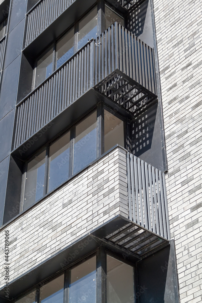 Fototapeta premium facade of new high-rise building with windows and compartments for external blocks of split systems. Fastening outdoor units of air conditioners