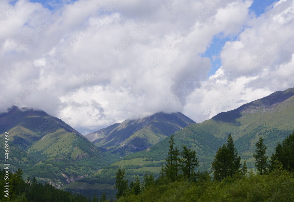 Obraz premium Evanescent atmosphere in the woods wrapped in clouds Tunka Valley and the East Sayan Mountains in Russia