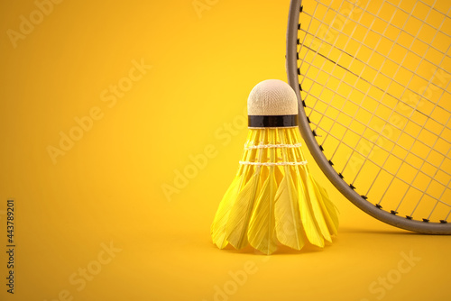 Badminton feather shuttlecock by badminton racket photo