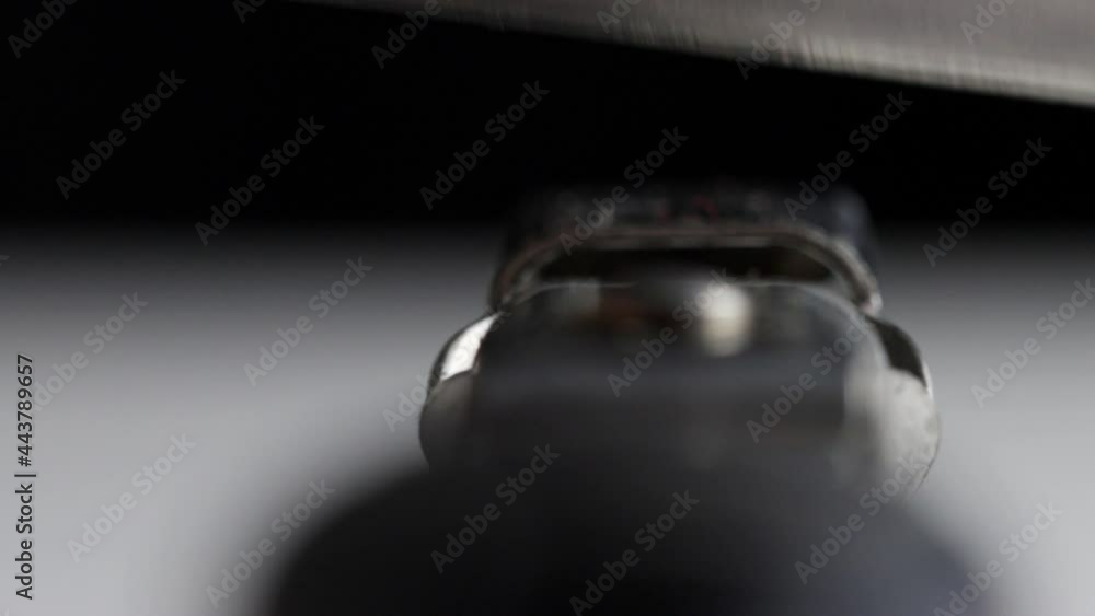 Sharpening a knife on a sharpener, black background. Macro, instrument Sharpening a knife on a sharpener, black background. Macro, instrument