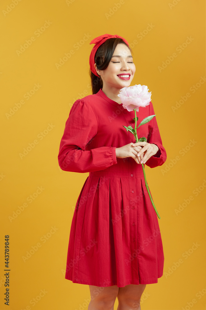 Beautiful young woman holding big pink peony. Beautiful young woman holding big pink peony.