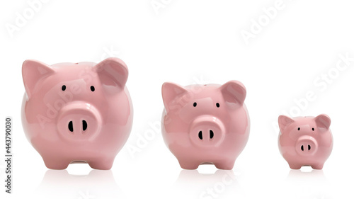 3 pink pig piggy banks on white background. Saving money. With clipping path.