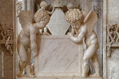 BOURG-EN-BRESSE, FRANCE, June 29, 2021 : Angels on graves in gothic Brou monastery church photo