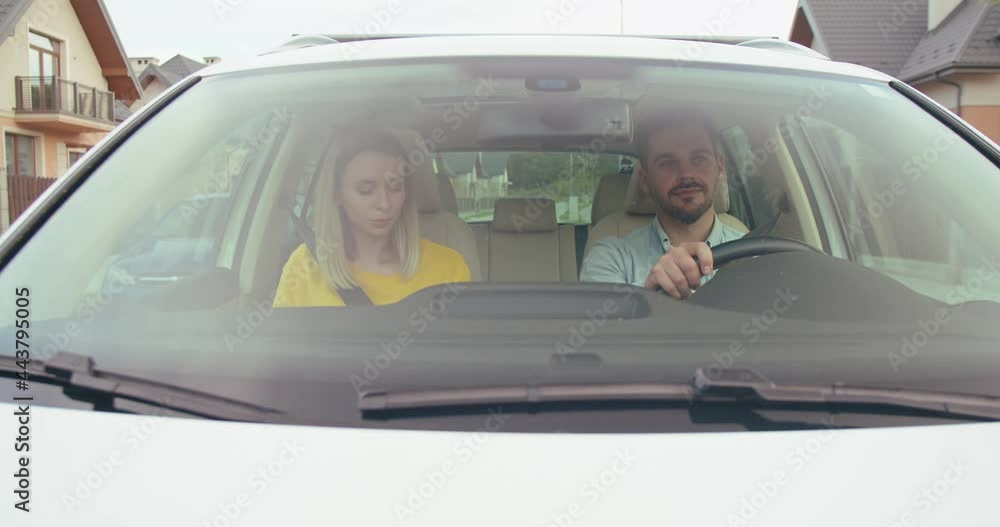Mirthful man and woman spending leisure time traveling by car and chatting with each other while searching the destination and feeling great mood during they adventure Mirthful man and woman spending leisure time traveling by car and chatting with each other while searching the destination and feeling great mood during they adventure