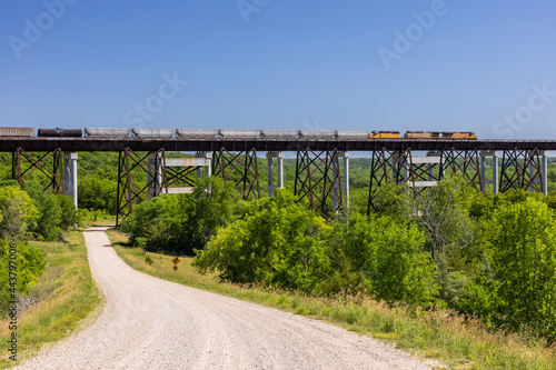 Freight Train Traveling Across High Trestle Bridge photo