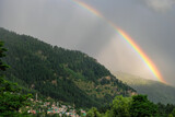 Manali, India - June 2021: Views of Manali with a rainbow in the background on June 23, 2021 in Manali, Himachal Pradesh, India.