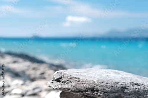 Stone rocky pedestal or podium in front of sea ocean background. Empty product template. Summer vibe. Mock-up. Stage for advertising