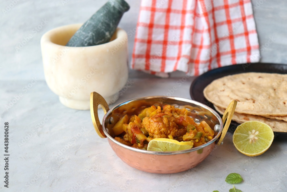 Aloo Gobi Mutter curry, cauliflower, and peas curry. Served with wheat roti. famous Indian curry dish with potatoes and green peas. Copy space Aloo Gobi Mutter curry, cauliflower, and peas curry. Served with wheat roti. famous Indian curry dish with potatoes and green peas. Copy space