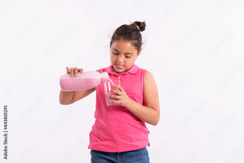 Little latina girl Serving herself strawberry milkshake in a glass: Expressions concept. Little latina girl Serving herself strawberry milkshake in a glass: Expressions concept.