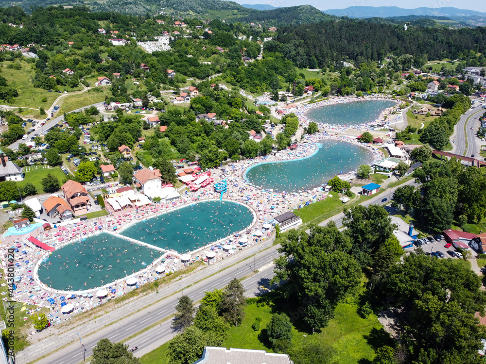 Pannonian Lakes Complex in Tuzla, Bosnia and Herzegovina. Aerial drone view of overcrowded open swimming pools during peak of tourist season. Tourist destination. Panonska jezera.