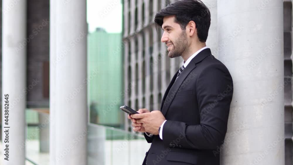 Handsome businessman using a mobile phone. Young man texting Messages, Social Networking. People. Apps. Handsome businessman using a mobile phone. Young man texting Messages, Social Networking. People. Apps.