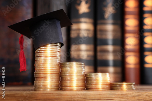 Wallpaper Mural Black Graduation cap over stack of coins Torontodigital.ca