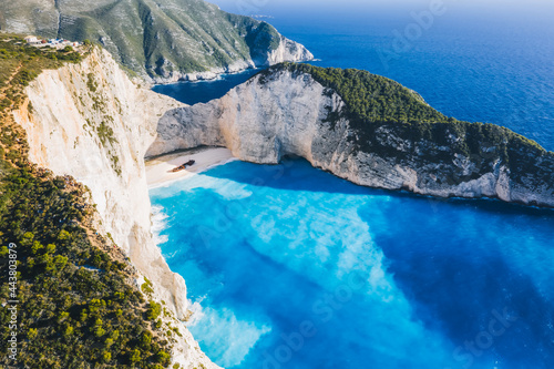 Aerial view of beautiful Navagio or Shipwreck beach on Zakynthos Island  Greece. Tourists on cliff edge enjoy view on summer travel trip