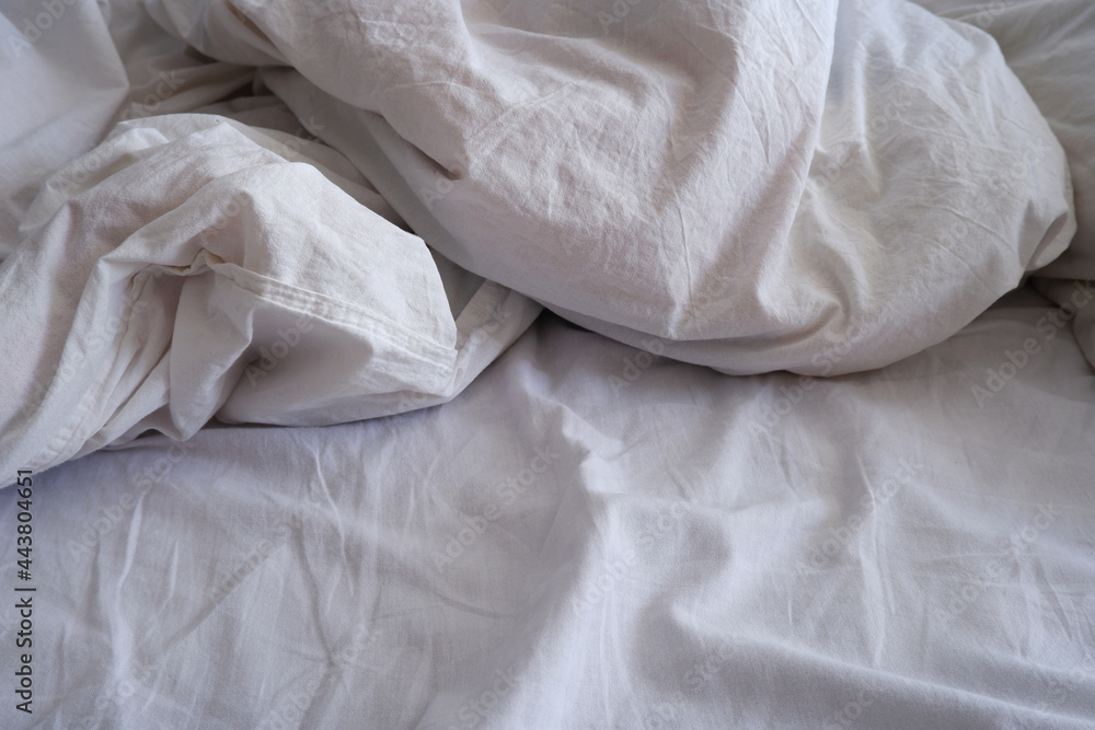 Bed linen texture. White bed linen background. Bed. Interior.