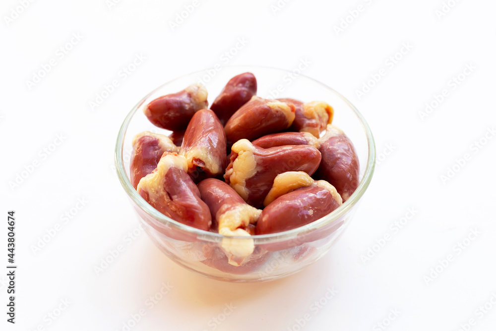 Fresh raw chicken hearts in glass bowl on white background Fresh raw chicken hearts in glass bowl on white background