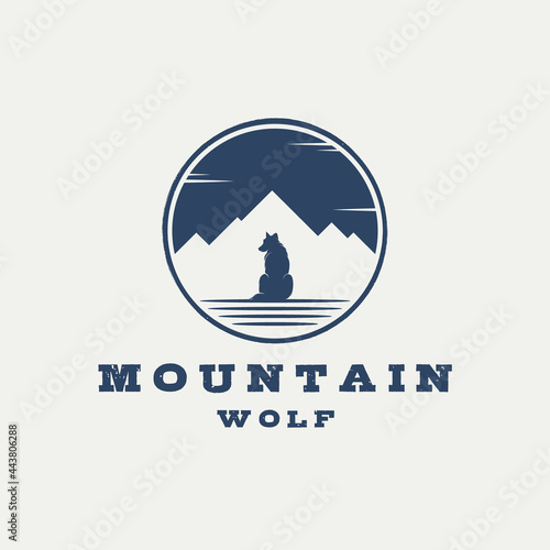 vintage retro badge label emblem sitting wolf logo with silhouette of mountain