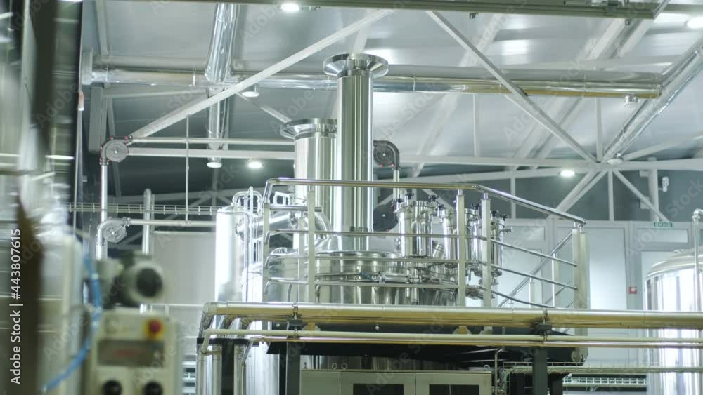 Modern craft brewery. Craft beer production. Modern equipment in brewery, metal tanks, alcoholic drink production Modern craft brewery. Craft beer production. Modern equipment in brewery, metal tanks, alcoholic drink production