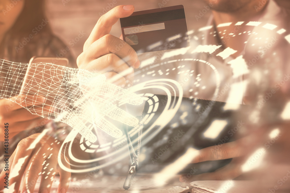 Double exposure of man and woman on-line shopping holding a credit card and data theme hologram drawing. Ai and E-commerce pay on-line concept. Double exposure of man and woman on-line shopping holding a credit card and data theme hologram drawing. Ai and E-commerce pay on-line concept.
