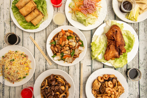 Dishes of popular Chinese gastronomy from European restaurants. Roast duck, chicken with almonds, beef with mushrooms, prawns with bamboo and mushrooms, Chinese salad.