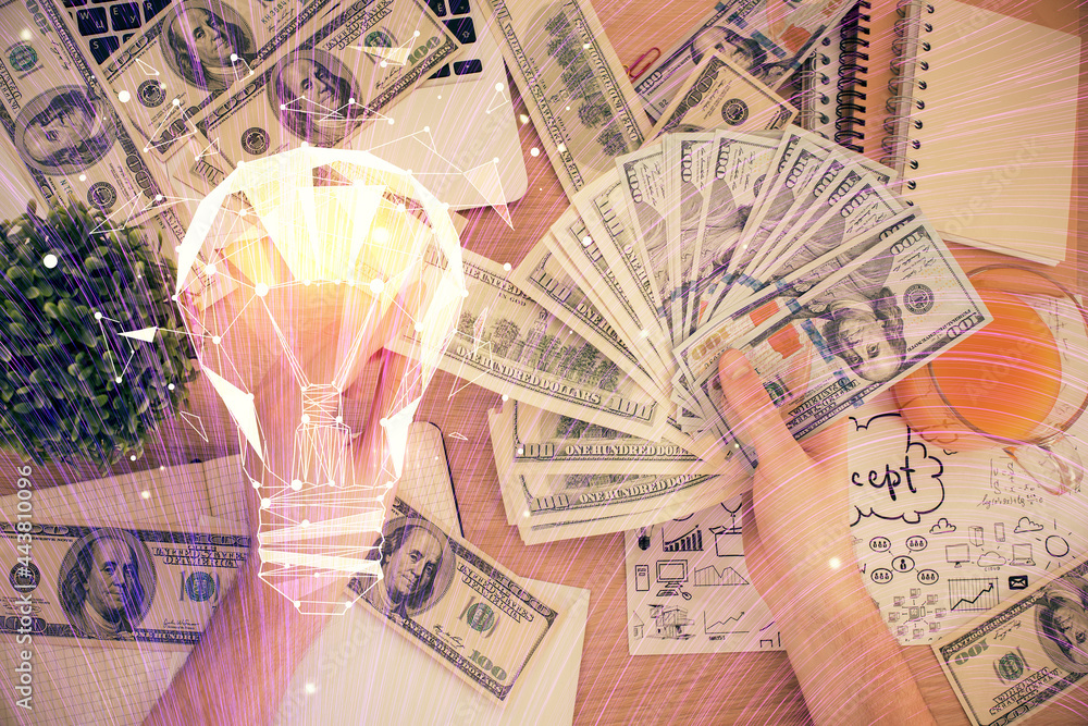 Multi exposure of bulb drawing hologram and USA dollars bills and man hands. Business Idea concept. Multi exposure of bulb drawing hologram and USA dollars bills and man hands. Business Idea concept.
