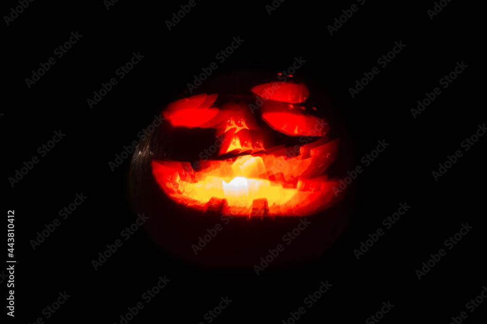 Halloween pumpkin with carved glowing face, blurred image. Halloween pumpkin with carved glowing face, blurred image.