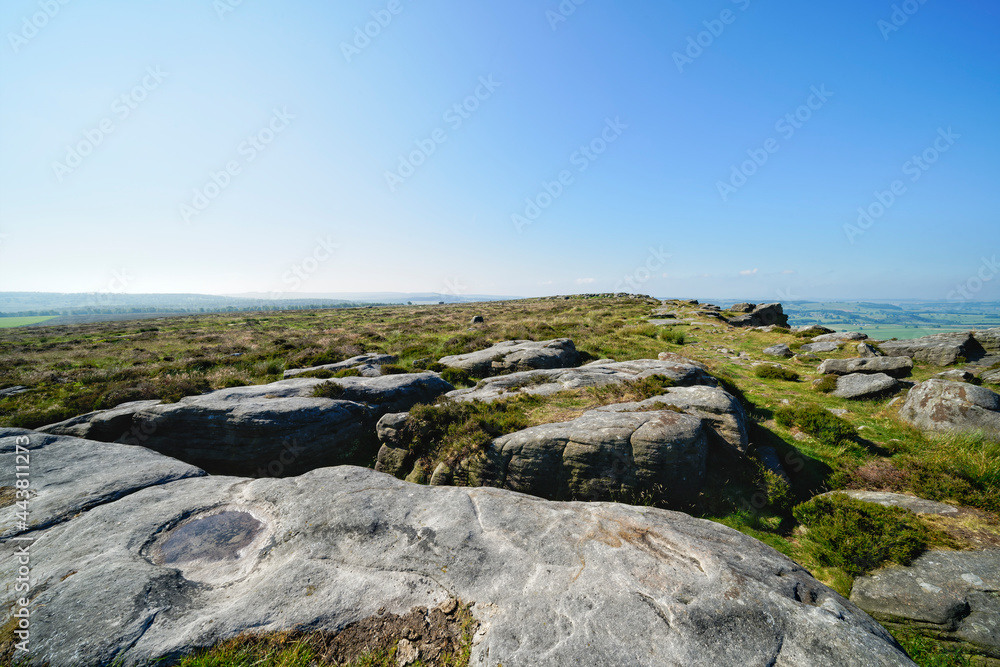 Large slabs of weathered gritstone lay across the top of Baslow Edge