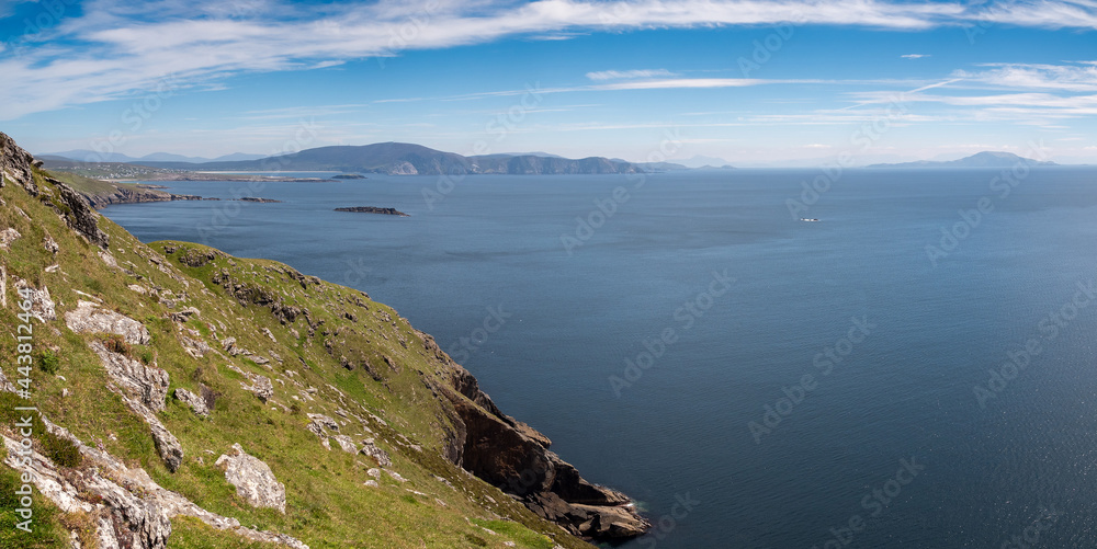 Panorama image view on Keem bay, Achill Island, county Mayo, Ireland, Warm sunny day, cloudy sky, blue ocean water surface