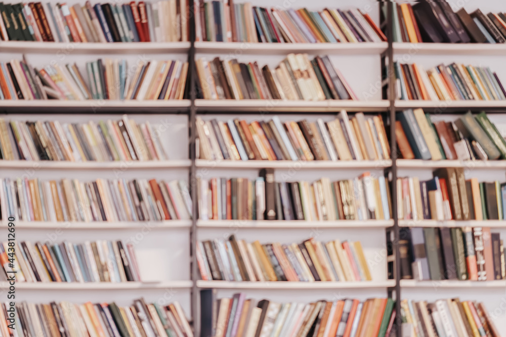 Bookshelves with books in public library, book store. Abstract blurred background. Learning, back to school, education Bookshelves with books in public library, book store. Abstract blurred background. Learning, back to school, education