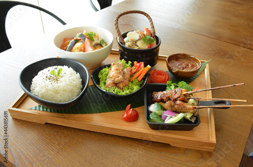 Photography asian bento party set with seafood soup, deep fried snack, chicken satay and pea