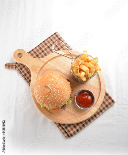 chef handmade deep fried crispy chicken tempura prawn cheesy burger with French fries and sauce western halal menu photo