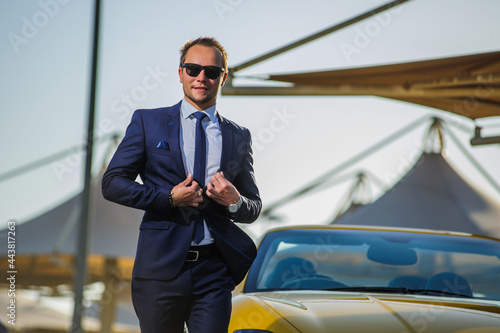 Successful yang businessman in yellow cabrio car. © manowar1973
