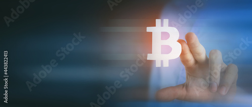 businessman clicks bitcoin icon on screen