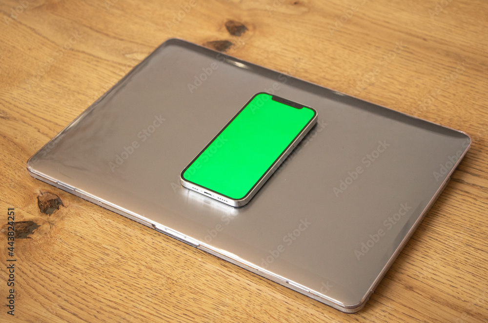 Laptop and telephone with green screen. Background. Mock up. Green screen. Laptop and telephone with green screen. Background. Mock up. Green screen.