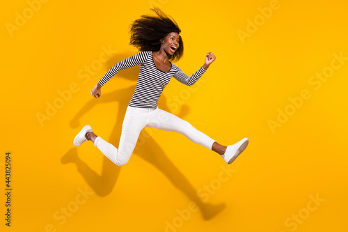 Full length body size side profile photo woman jumping up running on sale isolated vibrant yellow color background