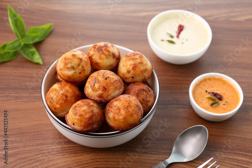 Paniyaram, Kuzhi paniyaram Gunta ponganalu paddu, guliyappa made of black lentils and rice deep fried snack or breakfast vegan vegetarian South Indian Kerala Tamil Nadu Karnataka Sri Lanka Lankan food photo