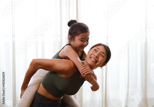 Happy and Healthy famly Mother and little daughter practice yoga and fitness at home, new normal lifestyle at home during corona virus disease photo