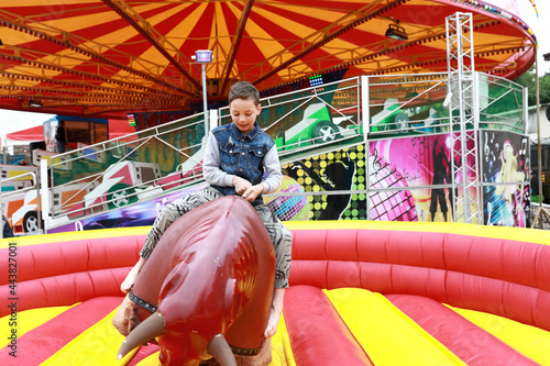 Boy riding on mechanical bull