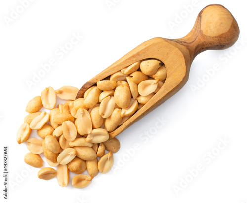 roasted peeled peanuts in the wooden scoop, isolated on white background, top view