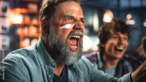 Photography At Home Three Joyfuls Sports Fans with Painted Faces Sitting on a Couch Watch Game on TV, Celebrate Victory when Sports Team Wins Championship