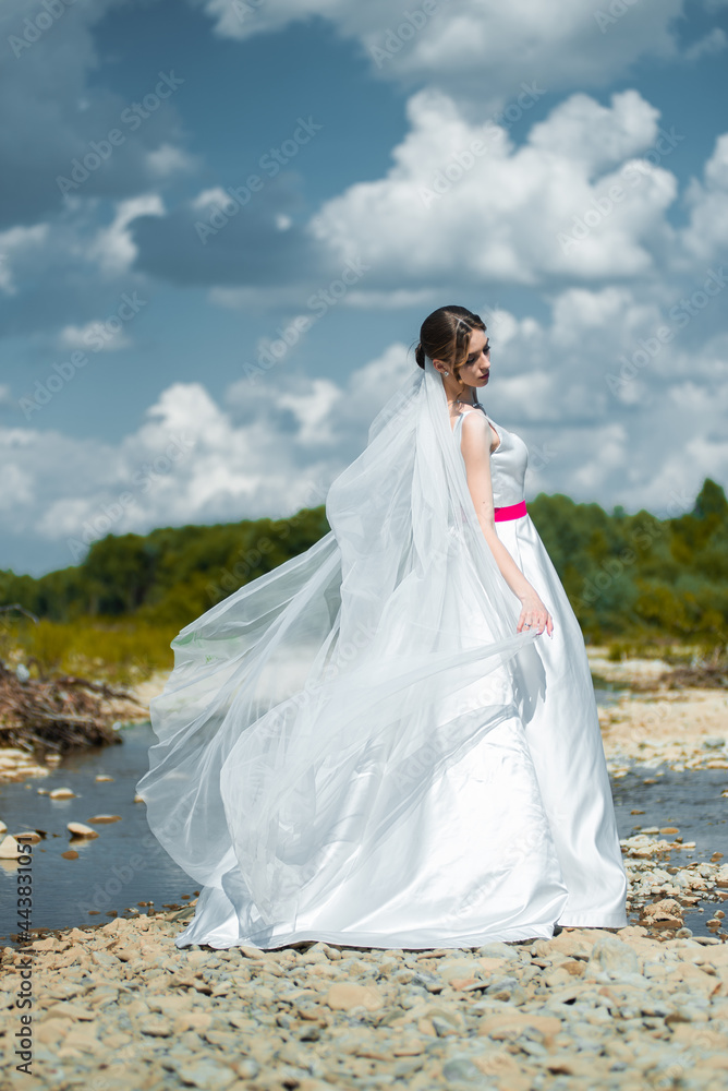 Young bride posing near the river Young bride posing near the river