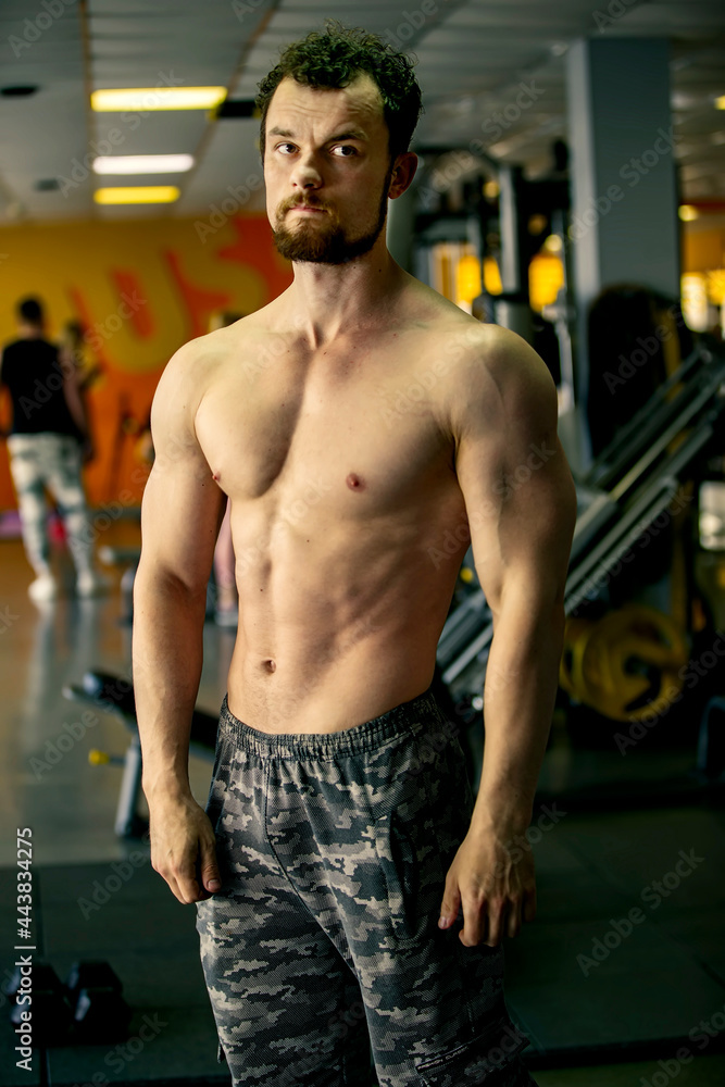 Handsome young man of athletic physique posing at the camera. Handsome young man of athletic physique posing at the camera.