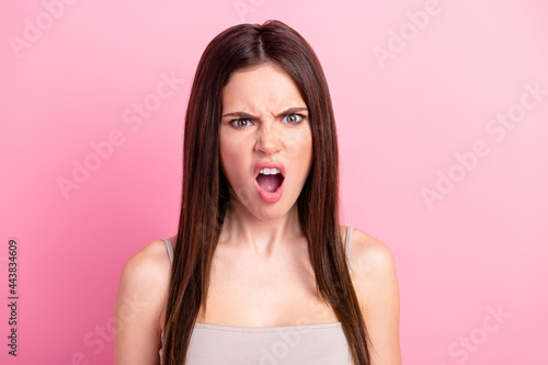 Photo of young girl unhappy sad angry furious mad crazy conflict scream trouble isolated over pink color background